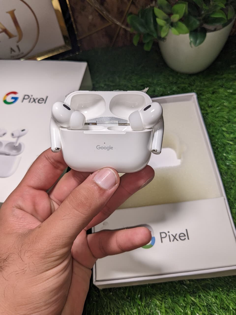 white Google buds open charging case with Earphones in hands. 