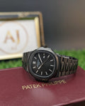 Patek Philippe watch on a red cushion with a blurred background