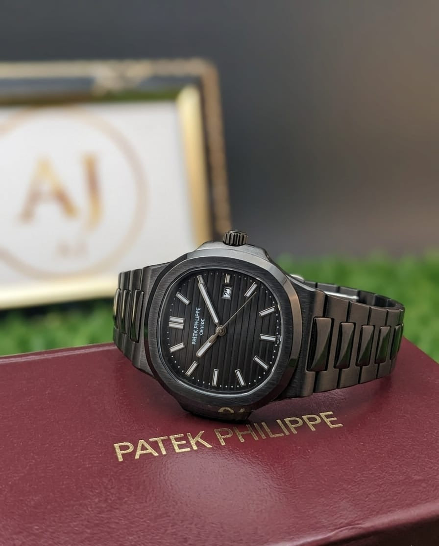 Patek Philippe watch on a red cushion with a blurred background
