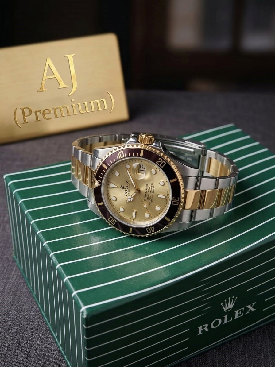 Luxury watch with gold and silver accents on a green Rolex box.